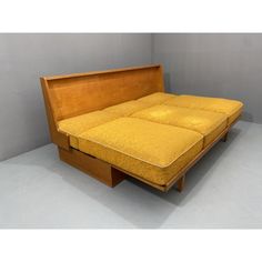 a bed that has been made into a couch with two drawers on the bottom side