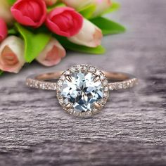 a close up of a ring with flowers in the background