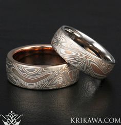 two wedding bands made to look like they have been carved into each other's rings