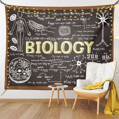 a chalkboard with the words biology written on it in front of a chair and table