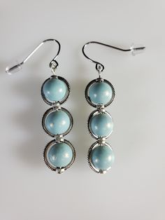 unique earrings. Blue frosted or faux pearl blue. Made in a smoke free, pet friendly environment. Elegant Light Blue Nickel-free Earrings, Elegant Light Blue Beaded Earrings, Nickel Free Light Blue Metal Earrings, Elegant Blue Hypoallergenic Beaded Earrings, Elegant Blue Beaded Hypoallergenic Earrings, Elegant Light Blue Round Bead Earrings, Elegant Light Blue Hypoallergenic Earrings, Elegant Light Blue Beaded Drop Earrings, Elegant Light Blue Round Beaded Earrings