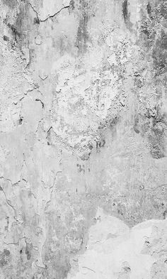 a black and white photo of a wall with peeling paint on it's surface