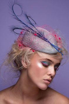 A stunning silver grey percher hat trimmed with three curled feathers and adorned with a delicate fuchsia veil . A focal point of this unique design are gracefully shaped cobalt blue feathers,  decorated with pale blue Swarovski crystals to create a delicate and magical effect, perfect for your special occasion . This awesome headpece is an arrangement of summery colours and a modern composition.  Perfect for a wedding, races or a cocktail party or any other special event. This sophisticated fea Silver Hat Headpiece For Party, Silver Party Hat Headpiece, Silver Headband Fascinator For Party, Silver Formal Hat Fascinator, Silver Formal Fascinator Hat, Silver Evening Hat Headpiece, Silver Hat For Evening At Royal Ascot, Silver Fascinator Hat For Formal Occasions, Silver Fitted Fascinator For Evening