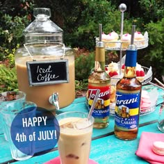 a table topped with drinks and desserts on top of it