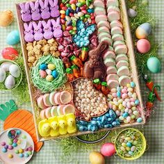 a tray filled with lots of different types of candy and candies on top of a table