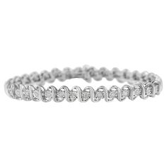 Elegant and timeless, this gorgeous sterling silver tennis bracelet features 1.0 carat total weight of round, miracle set diamonds. The tennis bracelet features S curved links with a single petite genuine round near colorless I-J color diamonds. These genuine stones are graded at I3 clarity, which is at the lower end of the diamond clarity grading scale; they may appear more cloudy than the photo shows, with visible natural inclusions. The 7” bracelet fastens with a box clasp with foldover figur Affordable Anniversary Bracelets With Round Beads, Silver Tennis Bracelet, Bracelet Tennis, Classic Bracelets, Tennis Bracelet Diamond, Best Diamond, Quality Diamonds, Tennis Bracelet, Silver Diamonds