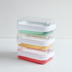 four plastic containers stacked on top of each other