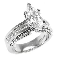 an engagement ring with a pear shaped diamond set in the center and channeled sides