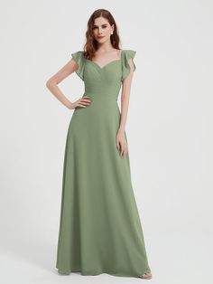 a woman in a long green dress with ruffles on the shoulders and shoulder