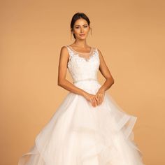 a woman in a white wedding dress posing for the camera with her hands on her hips