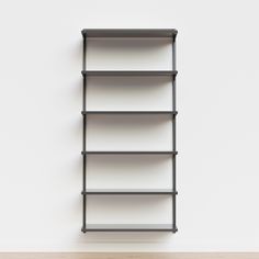 an empty book shelf against a white wall