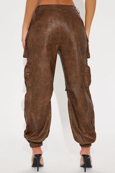 Available In Brown. Washed Faux Leather Jogger High Rise Button & Zip Closure Hand & Back Pockets Cargo & Utility Details Non Stretch Shell Coating: 100% Polyurethane Basic Fabric/Lining: 100% Polyester Imported | Weekend Warrior Washed Faux Leather Cargo Jogger Pant in Brown size XL by Fashion Nova Utility Faux Leather Bottoms With Pockets, Utility Style Faux Leather Bottoms With Pockets, Casual Faux Leather Cargo Pants With Pockets, Casual Faux Leather Pants With Side Pockets, Utility Faux Leather Pants With Pockets, Utility Faux Leather Bottoms For Fall, Faux Leather Utility Bottoms For Fall, Casual Faux Leather Cargo Pants With Belt Loops, Faux Leather Bottoms With Pockets For Winter