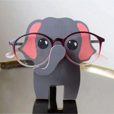 an elephant wearing glasses on top of a table