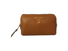 This Prada vanity case is so cute and coordinates beautifully with all of Prada's Vitello Daino leather collection! The size is perfectly compact to hold your essential cosmetic items that you may want to take with you on a trip or out for the day. Throw this in your handbag and store your items classically. Features a zip closure and gorgeous gold-tone Prada emblem on the front and a black lined interior.     Model: 1ND004  Cannella brown    Vitello Daino calfskin leather  Gold-tone hardware  P Designer Compact Travel Bags, Designer Cosmetic Bag For Daily Use, Luxury Brown Cosmetic Bag For Travel, Luxury Brown Cosmetic Bag For Daily Use, Luxury Brown Travel Cosmetic Bag, Designer Travel Cosmetic Bag With Removable Pouch, Luxury Brown Cosmetic Bag With Removable Pouch, Elegant Brown Cosmetic Bag With Removable Pouch, Luxury Brown Rectangular Cosmetic Bag