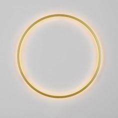 a circular light that is on top of a white wall with no one around it