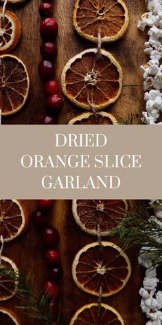 dried orange slice garland on a wooden table with berries and cotton flowers in the background