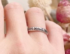 a person's hand with a ring that says, never know what you are