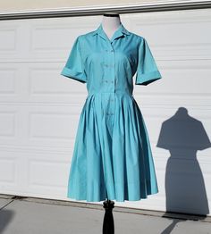 "Who doesn't love a vintage Sears dress? This beauty is a lovely light blue shirt dress with a double breasted front panel with topstitching detail.  This would make a lovely every day dress, or it is perfect for an Alice in Wonderland vintage look or cosplay!! Beautiful pleating on the skirt, original thread belt loops are still on the dress, but the original belt is not included. It would look great with any number of other belts, so many colors would go beautifully with this blue!  Front butt Fitted Cotton Solid Color Shirt Dress, Fitted Cotton Solid Shirt Dress, Fitted Solid Color Cotton Shirt Dress, Fitted Cotton Shirt Dress, Classic Blue Shirt Dress For Summer, Classic Vintage Short Sleeve Dress For Spring, Classic Short Sleeve Vintage Dress For Spring, Fitted Collared Light Blue Dress, Light Blue Fitted Collared Dress