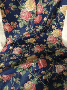 a blue floral fabric with pink and yellow flowers