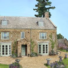 a painting of a stone house with flowers in the foreground and trees on either side