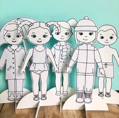 three paper dolls are standing next to each other