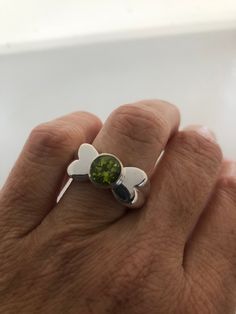 Rich bright Peridot green ring Sterling silver Tarnished with age, can be polished up. Size 7 can be sized by my jeweler. His service charge is $10-$20 All rings are shipped free in the US in a nice gift box. Check out our over a THOUSAND great reviews Engraving is $4 per letter and is not always perfect depending on the piece. It can take a few days if the jeweler is busy. This is payable to Paypal Judithsltd@gmail.com Lime Green Sterling Silver Rings As Gift, Lime Green Sterling Silver Rings For Gift, Green Sterling Silver Open Ring, Green Sterling Silver Rings With Bezel Setting, Lime Green Sterling Silver Rings, Green Sterling Silver Rings With Stone Setting, Sterling Silver Lime Green Rings, Green Sterling Silver Rings With Polished Finish, Lime Green Sterling Silver Round Rings