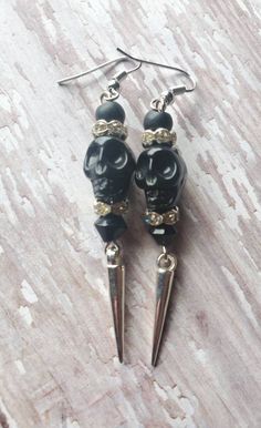 FREE DOMESTIC SHIPPING ONLY Please read the shipping, policies, and procedures Personal handmade fave! Spooky cool black skull earrings accompanied by matte black rounds, diamond-like crystal rondelles, and glass jet black bicone with silver dangling spikes. The earrings dangle at 2.75 inches (1cm in width), very light weight. The black skulls have intricate detailing and the earrings are created with silver tone plated precious metals. These earrings make a great fashion statement, especially f Adjustable Black Skull-shaped Earrings, Nickel Free Black Skull Earrings, Black Skull Earrings For Gift, Edgy Adjustable Earrings For Halloween, Adjustable Black Skull Earrings, Handmade Black Skull Earrings, Handmade Punk Earrings For Party, Edgy Skull Earrings For Parties, Handmade Punk Style Earrings For Parties