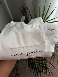 Personalized Embroidered Wife Sweatshirt | Custom last name Sweatshirt | Bridal Sweatshirt | Engagement Sweatshirt | Bride To place your order, simply select the size, style (t-shirt or sweater), and colour of the garment from the drop-down menus. Please remember to reference the size chart included in the listing photos to make sure you are ordering the correct size! Each item is handmade and packaged with love, care, and attention to detail. S T Y L E  &  F I T  >Gildan G180 - Heavy Blend™ 8 o Fitted Long Sleeve Top With Custom Embroidery, White Long Sleeve Top With Custom Embroidery, White Custom Embroidery Relaxed Fit Tops, White Tops With Custom Embroidery Relaxed Fit, White Relaxed Fit Top With Custom Embroidery, Fitted Long Sleeve Embroidered T-shirt, Long Sleeve T-shirt With Custom Embroidery In Relaxed Fit, White Long Sleeve T-shirt With Embroidered Text, Fitted Long Sleeve Tops With Embroidered Logo