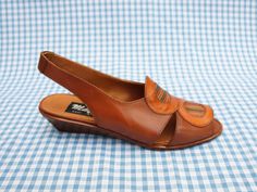 "These shoes are previously unworn ex shop stock from the 1980s. They were handmade in Italy and have been made from genuine Italian leather. They have a small wedge heel, a slingback strap at the back and a leatherwork circle pattern on the front. They are very good quality \"Mayfair\" shoes and they come in their original box. They are beautifully made and look beautiful when worn. The heel height is 4cm. The shoes are slightly smaller than modern sizing in my experience - please get in touch for more detailed measurements! As these shoes are unsold vintage shop stock, they come in a variety of sizes. Please see the drop-down list to the right for available sizes." Vintage Brown Low Heel Sandals, Vintage Brown Sandals With Low Heel, Retro Slingback Summer Sandals, Retro Slingback Sandals For Summer, Vintage Open Heel Wedge Sandals For Summer, Retro Brown Sandals For Formal Occasions, Vintage Brown Wedge Sandals For Spring, Brown Retro Wedge Sandals For Summer, Retro Brown Formal Sandals