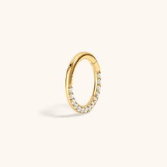 an open gold ring with white diamonds