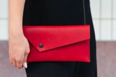 A unique clutch with asymmetric design will perfectly complement your outfit. In this simple handbag, you will find space for all the necessary things like phone, papers, keys and other things. The clutch has an adjustable shoulder strap made of round leather, which can be removed completely. Dimensions: 26 x 13 cm Made of high-quality vegetable tanned full grain leather. Each piece is original. Would you like to add initials or full name to the product? Or would you like the clutch to have a di Modern Rectangular Clutch With Card Slots, Modern Rectangular Clutch With Interior Card Slots, Modern Clutch With Interior Card Slots, Modern Clutch With Magnetic Closure, Trendy Clutch With Interior Card Slots For Daily Use, Evening Clutch Shoulder Bag With Interior Card Slots, Evening Leather Shoulder Bag With Interior Card Slots, Minimalist Formal Clutch With Removable Pouch, Trendy Leather Clutch Evening Bag