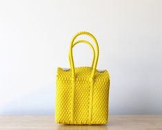 WHY YOU WILL LOVE IT: * Small handbags, super colorful and handmade. * Handwoven Handbag in Yellow Color.* Our tiniest bags.* Made from recycled plastic.* Unique styles, embodying slow fashion.* Perfect for any occasion and adding a pop of color to your outfit.* Crafted by Mexican artisans from Jalisco. Yellow Handbag Outfit, Mexican Bags, Mexican Bag, Tiny Bag, Handwoven Bag, Basket Tote, Yellow Handbag, Handbag Outfit, Mexican Designs