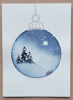 a watercolor christmas ornament with a snow covered tree on it's side