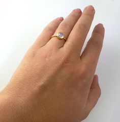 This beautiful stackable bezel set ring features round faceted Rainbow Moonstone gemstone in 18K Vermeil Gold. The ring has a 925 stamp. Gemstone size is 6 mm. Please specify your size at the checkout. ALSO AVAILABLE IN STERLING SILVER. Since I use natural gemstones, the stones may vary slightly in color and shape. Ring will be shipped in Danique Jewelry gift box. ★ Please read the shop announcement to know the current PRODUCTION TIME. ★ Different shipping options including EXPEDITED SHIPPING ar Gold Moonstone Ring Fine Jewelry With Birthstone, Dainty Handmade Round Band Ring, Handmade Dainty Round Band Ring, Modern Everyday Crystal Ring, Dainty Stackable Moonstone Jewelry, 14k Gold Crystal Ring For Everyday, Stackable Moonstone Jewelry Gift, Adjustable Moonstone Ring For Everyday, Adjustable Everyday Moonstone Ring