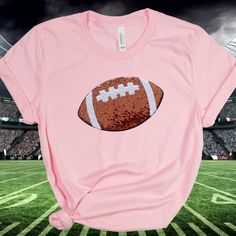 You are going to love this Sequin Football Tshirt!   A great shirt for the entire football season.   Awesome for a Football Mom Shirt and more.  In a choice of shirt colors, you can't go wrong! Large Sequin football at appx. 9 3/4 inches. Makes a great group shirt too! >Click on the drop down menu to see size and color options. >High end super soft and comfy tee. > Comes in a variety of shirt color options.  (Red, White, Navy, Heather Peach, Pink, Heather Green and Black.) > Sequin Football is a Football Season Tops With Team Logo For Sports Fans, Sports Fan Tops With Team Logo For Football Season, Sports Fan Short Sleeve Shirt For Football Season, Short Sleeve Shirt For Football Season Sports Fans, Game Day Pre-shrunk Shirt For Sports Season, Football Season T-shirt With Team Logo, Football Season Team Name Sports Fan Shirt, Football Season Team Logo T-shirt, Football Season Fan Apparel Shirt