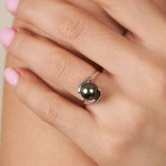 This Embrace ring holds an 8.0-9.0 mm, AAA quality, Tahitian pearl. The ring's two loops of gold embrace the pearl with two loops of gold wrapped like arms around the perfectly spherical pearl. For decades our buying team has been making regular trips to French Polynesia to source these incredibly colorful pearls. Because we personally import every Tahitian pearl we offer, we can guarantee they are 100% natural color and have never been treated in any way. Colorful Pearls, Tahitian Pearl Ring, Black Pearl Ring, Ring Pearl, Tahitian Black Pearls, Gold Wrap, Pearl Types, Tahitian Pearls, The Pearl