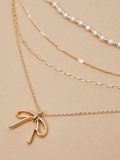 Add a dash of charm to your look with our super dainty and adorable necklace featuring a bow charm and delicate pearl detailing. This elegant accessory exudes timeless beauty, perfect for effortlessly elevating any ensemble with its whimsical and graceful allure. Preppy Christmas List, Preppy Christmas, 2024 Christmas, Bow Necklace, Bow Jewelry, Accessories Jewelry Necklace, Elegant Accessories, Sweater Sale, Altar'd State