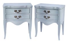 two white nightstands side by side with gold handles