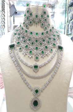 an elaborate necklace and earring set on display