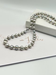 Freshwater potato Pearl and Swarovski crystal necklace. silver grey genuine potato pearls. Perfect for a bride who wants to be a little bit different, mother of the bride/groom or wedding guest. Would make a gorgeous gift for that someone special. Pearls are June's birthstones. Approximately 18" long. Magnetic clasp, please note, *magnetic clasps are not suitable if you have a pacemaker* Necklace comes beautifully packaged in a box. Pearls are typically considered a symbol of wisdom, prosperity, Gray Pearl Drop Jewelry For Gift, Silver Akoya Pearl Necklace With Round Beads, Gray Pearl Necklace For Gift, Silver Baroque Pearl Necklace For Anniversary, Gray Pearl Necklace For Gifts, Silver Tahitian Pearl Necklace With Pearl Charm, Silver Tahitian Pearl Necklace With Pearl Drop, Elegant Gray Necklace For Gift, Tahitian Pearl Drop Necklace For Wedding