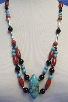 This native necklace was lovingly made by hand. NEVER worn. It is an all-natural masterpiece of turquoise, onyx and red stone beads with sterling silver accents.  Exceptionally well made & strung on wire cable.  Can be adjusted from 24 to 26 inches.  Dress it up or dress it down, it's very versatile.   Please ask any questions and thank you for visiting! Southwestern Double Strand Beaded Necklaces, Southwestern Turquoise Gemstone Necklace For Healing, Handmade Double Strand Southwestern Necklace, Handmade Southwestern Double Strand Necklace, Native Necklace, Silver Centerpiece, Retro Ring, Red Stone, Pandora Bracelet