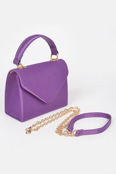 * Satin evening clutch bag. * Top handle. * Magnetic closure in front. * Gold chain cross body included. * 6.5" width, 5" height, 2.75" depth. Chic Purple Shoulder Bag For Party, Chic Purple Evening Bags, Chic Purple Evening Bag, Purple Clutch Shoulder Bag For Formal Occasions, Formal Purple Clutch Shoulder Bag, Chic Purple Bag For Events, Purple Evening Shoulder Bag With Detachable Handle, Evening Purple Shoulder Bag With Detachable Handle, Purple Shoulder Bag With Detachable Handle For Evening