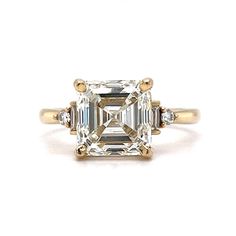 an emerald cut diamond ring with three baguets