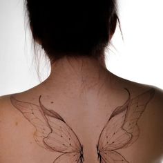 a woman with a butterfly tattoo on her back