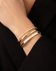 Why We Love It: Inspired by our best-selling Open Diamond Wrap Ring, this polished gold bangle elegantly wraps around the wrist in a modern design. It is sure to add a unique, eye-catching element to your wrist stack. Shop our coordinating Open Gold Wrap Ring for the full look. Luxury Diamond Bangle Gold Bracelet, Luxury Classic Bangle With Prong Setting, Luxury Classic Hinged Bangle, Gold Bangle Modern Design, Modern Gold Bracelet For Women, Modern Gold Bangles For Women, Modern Gold Bracelet, Modern Gold Jewelry Unique Designs, Diamond Bracelet Design Unique