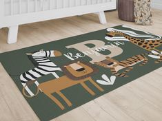 a rug with animals and zebras on it in a nursery room, next to a crib