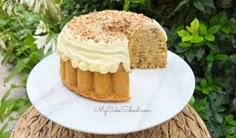 a white plate topped with a cake covered in frosting