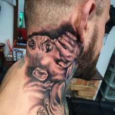 a man with a lion tattoo on his neck