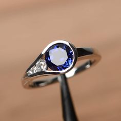 It is a lab sapphire ring. The main stone is 7mm*7mm round cut, weight about 1.63 carats. The basic metal is sterling silver and plated with rhodium. To change the metal to a solid gold (white/rose) or platinum is also available, please ask for a quotation if you want. You can also go to my shop Home for more elegant rings: https://www.etsy.com/shop/godjewelry?ref=hdr_shop_menu Sapphire is the birthstone of September. More sapphire rings: https://www.etsy.com/shop/godjewelry?ref=listing-shop2-al 2 Stone Rings Gemstones, Round Sapphire Engagement Ring, Octagon Ring, Elegant Rings, Sapphire Wedding Rings, September Birthstone Rings, Blue Gemstone Rings, Sapphire Rings, Sapphire Engagement Ring Blue