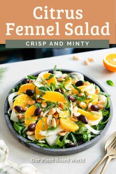 citrus fennel salad in a black bowl with oranges and nuts on the side